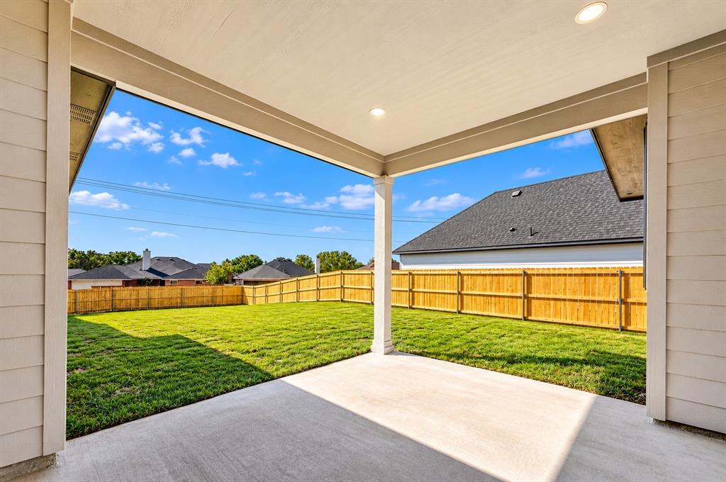1632 West Wintergreen Road Lancaster, TX 75134 - Photo 25 of 30 Covered patio with recessed lighting, concrete flooring, and a spacious green lawn