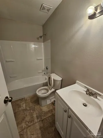a bathroom with a toilet sink and shower
