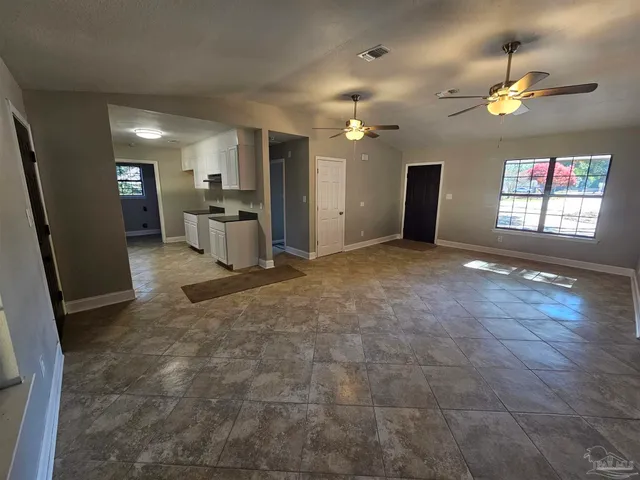 a view of a kitchen with a sink a refrigerator and a stove