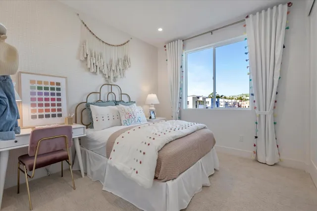 a bedroom with a bed a table and chair