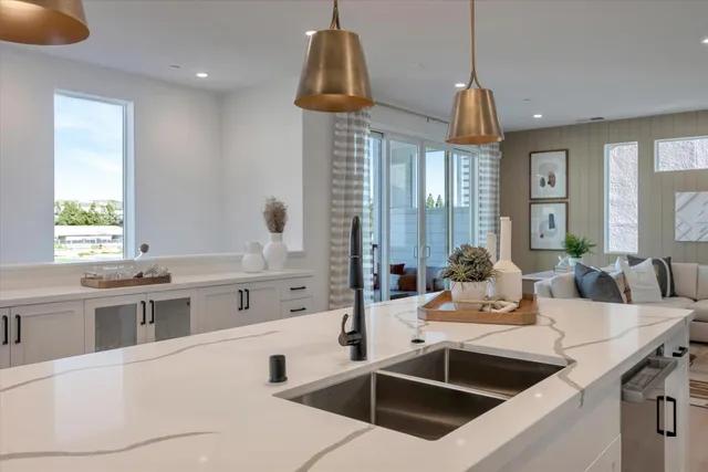 a kitchen with stainless steel appliances a sink a stove top oven a counter space and a window