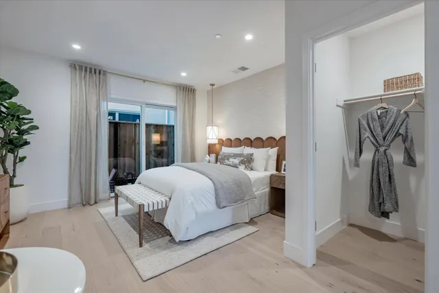 a bedroom with a bed and ceiling fan