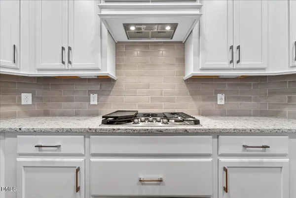 a kitchen with kitchen island granite countertop a sink appliances cabinets and counter space