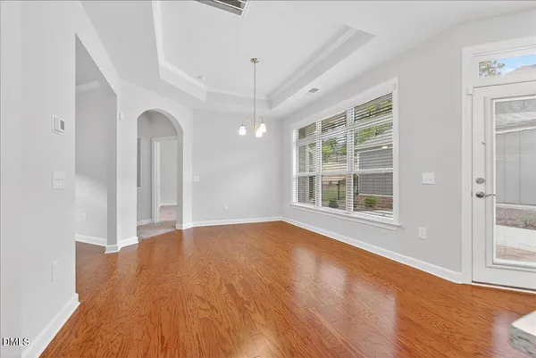 a view of a room with wooden floor