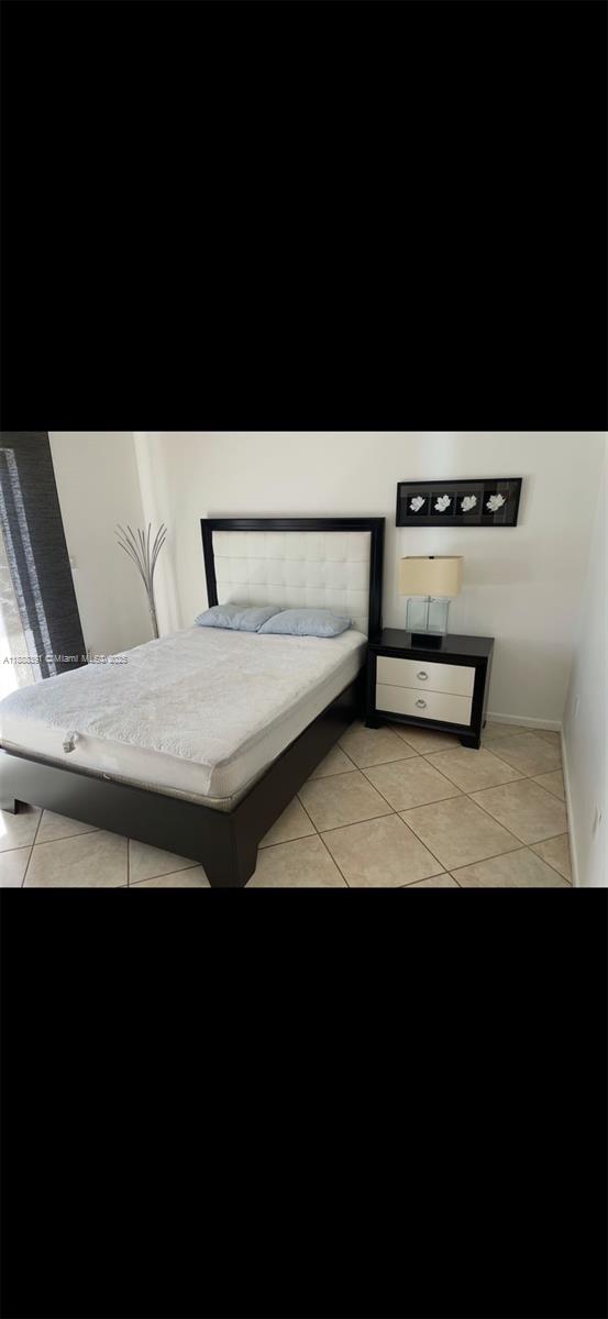8255 Abbott Avenue, Unit 402 Miami Beach, FL 33141 - Photo 14 of 32 a view of a bedroom with a bed