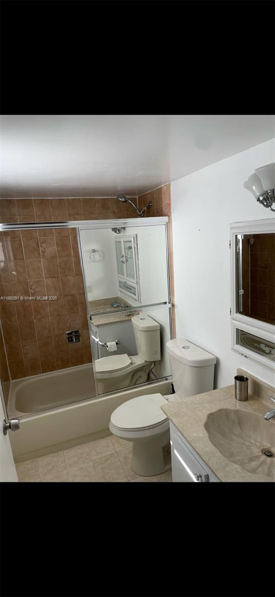 8255 Abbott Avenue, Unit 402 Miami Beach, FL 33141 - Photo 18 of 32 a bathroom with a sink a toilet and a bathtub