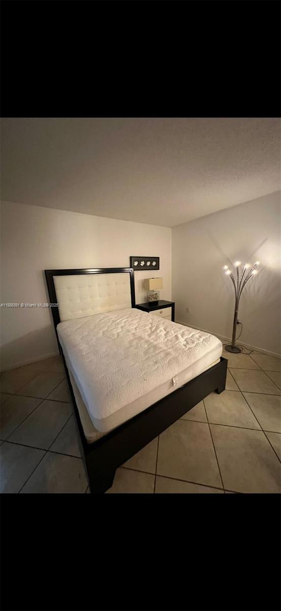 8255 Abbott Avenue, Unit 402 Miami Beach, FL 33141 - Photo 23 of 32 a view of a room with a bed