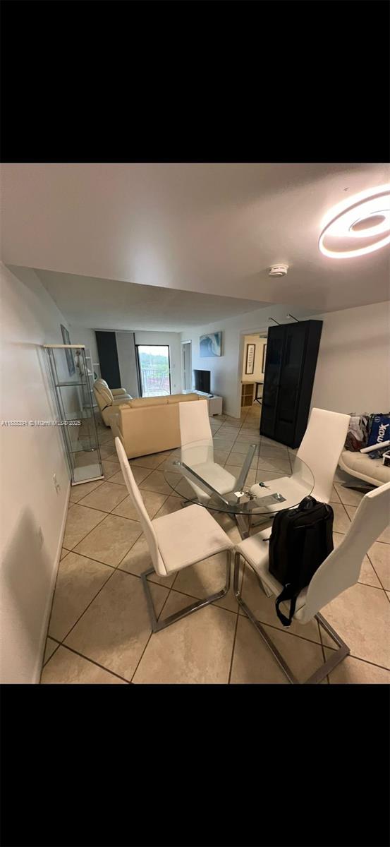 8255 Abbott Avenue, Unit 402 Miami Beach, FL 33141 - Photo 3 of 32 a living room with furniture and a flat screen tv