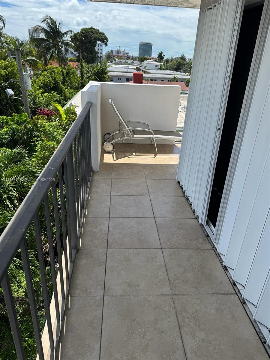 8255 Abbott Avenue, Unit 402 Miami Beach, FL 33141 - Photo 31 of 32 a view of a balcony with an outdoor space