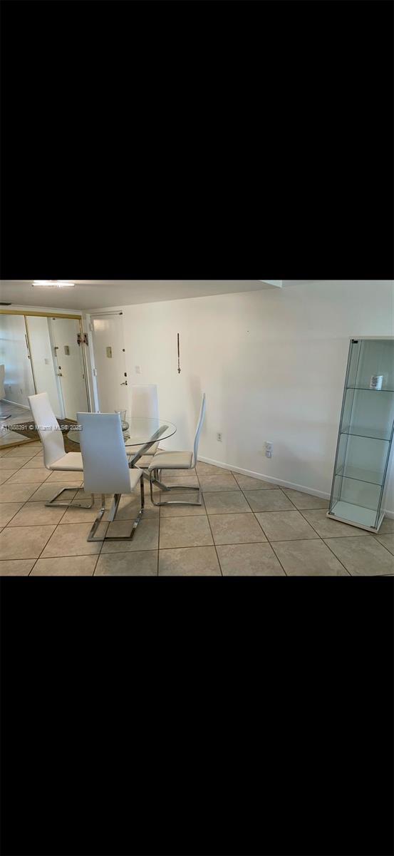 8255 Abbott Avenue, Unit 402 Miami Beach, FL 33141 - Photo 4 of 32 a view of wooden floor and a cabinet