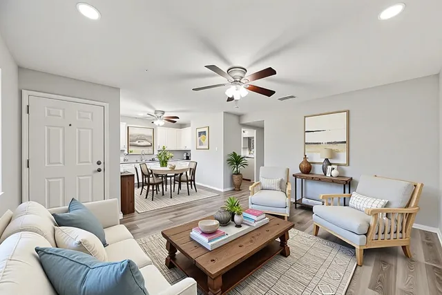 a living room with furniture a rug and a chandelier