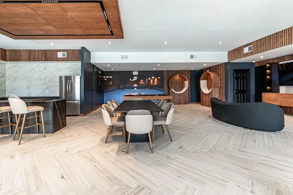 a living room with furniture a ceiling fan and a rug