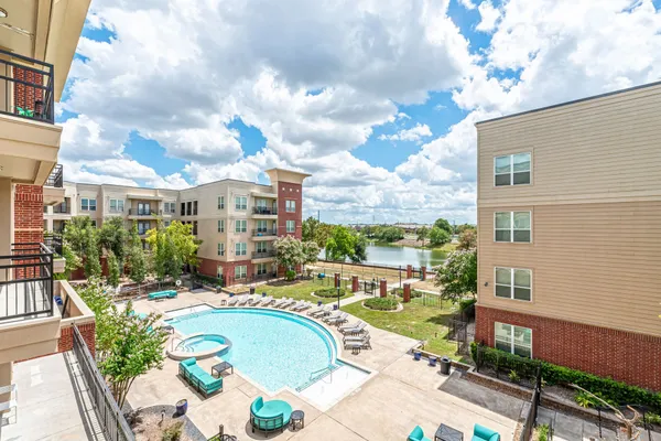 a swimming pool with outdoor seating and yard