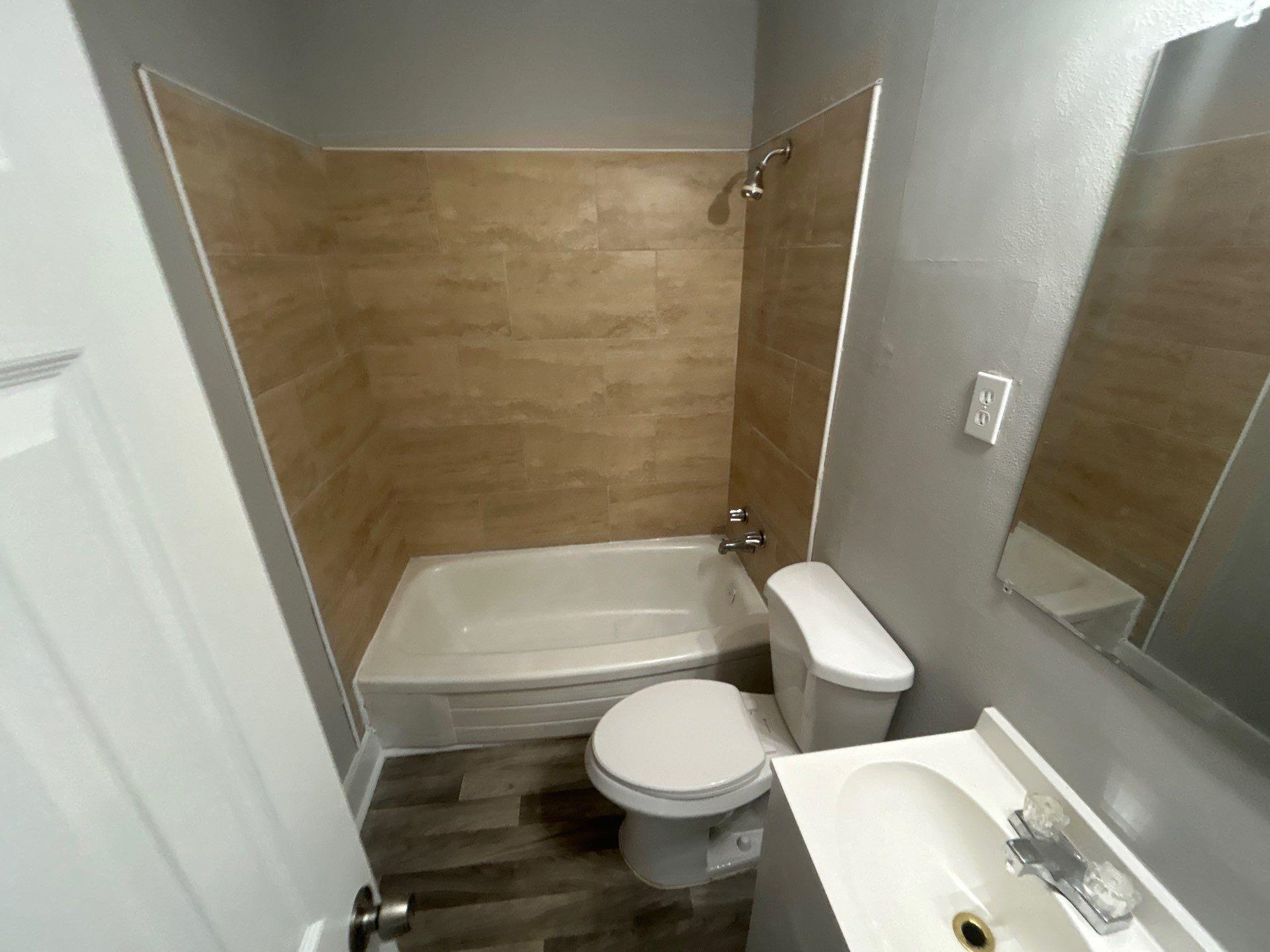 4989 Neely Road Memphis, TN 38109 - Photo 2 of 8 a bathroom with a toilet and a shower