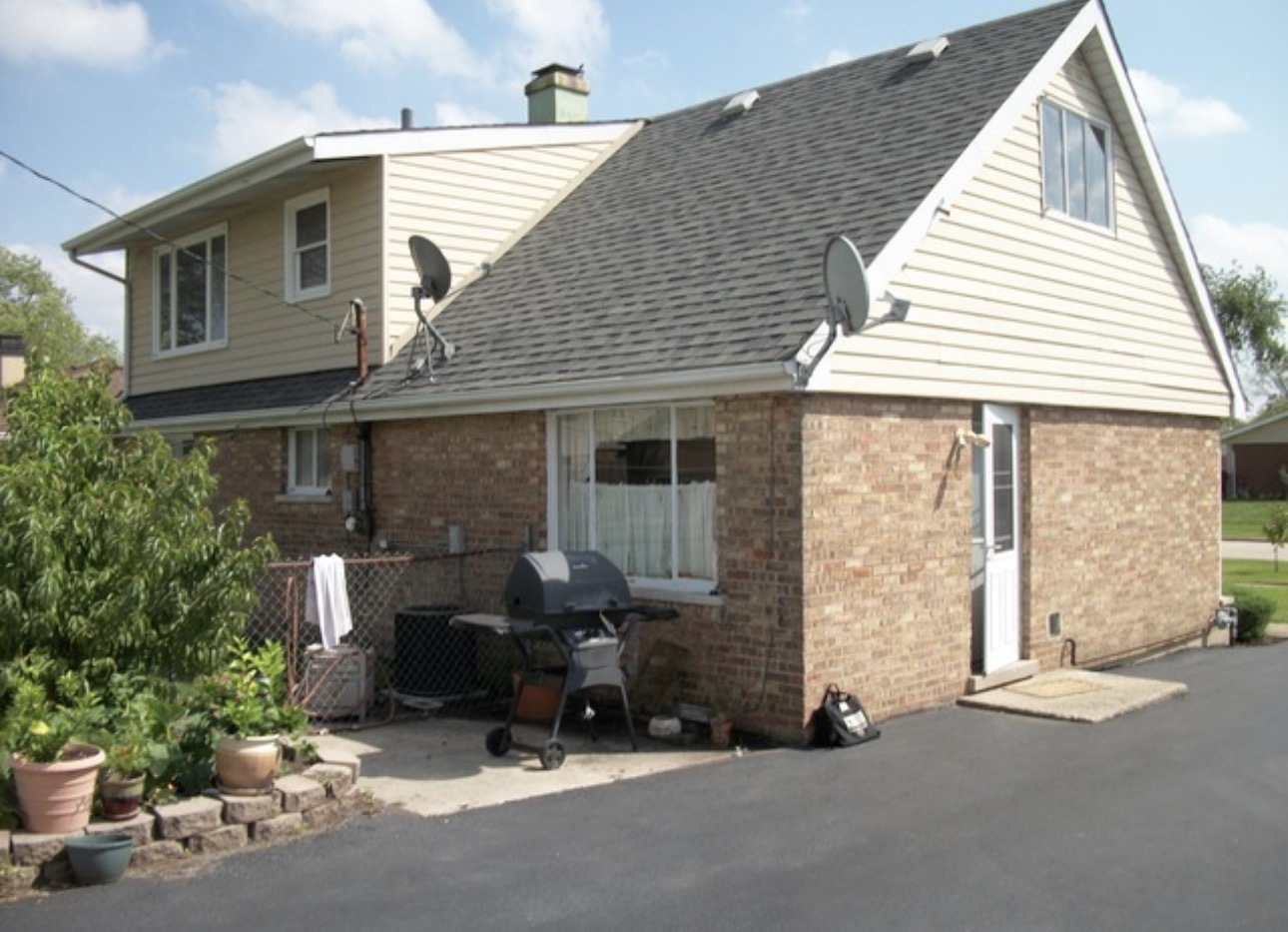 6932 West 91st Street Bridgeview, IL 60455 - Photo 3 of 3 a view of backyard with a chair and potted plants
