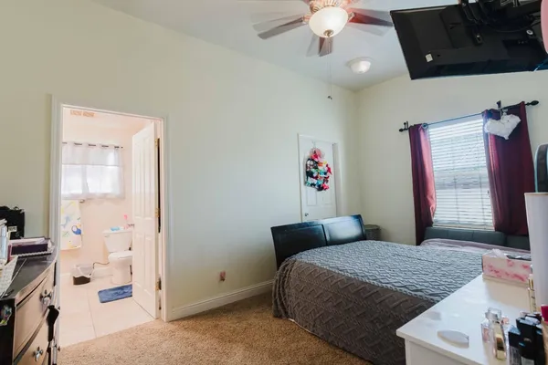 a bedroom with a bed and a television