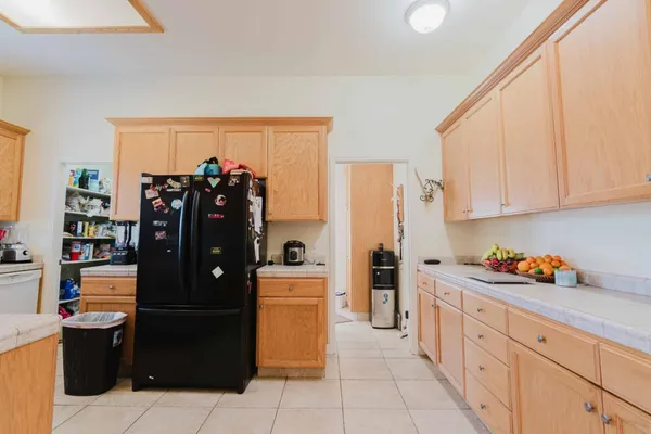 a kitchen with a refrigerator and cabinets