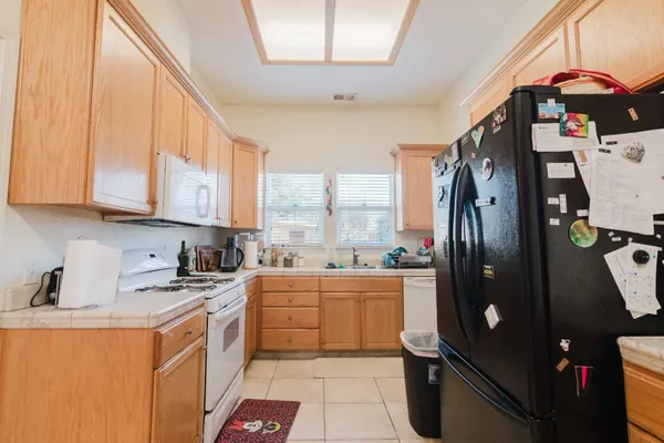 a kitchen with stainless steel appliances a refrigerator sink and cabinets