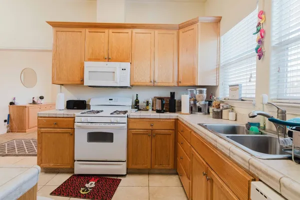 a kitchen with a sink cabinets and window