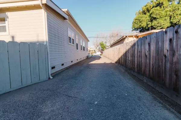 a view of a backyard with wooden fence