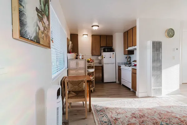 a view of kitchen with stainless steel appliances kitchen island microwave and cabinets