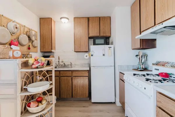 a kitchen with a refrigerator and a sink
