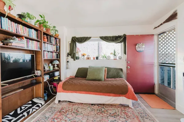 a bedroom with furniture and a flat screen tv