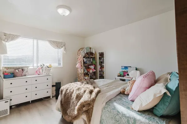 a bed room with a bed and a window