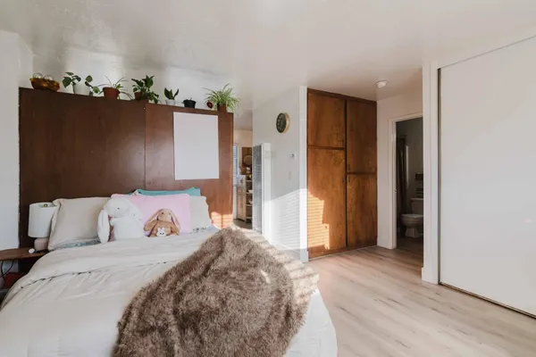 a bedroom with a bed and a dresser