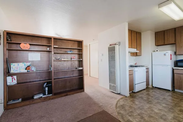 a kitchen with a refrigerator and cabinets