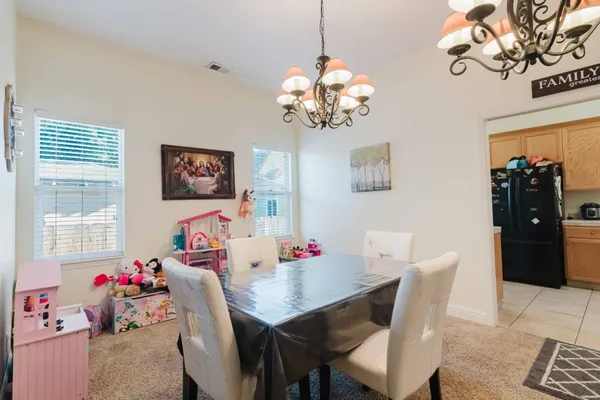 a view of a dining room with furniture and chandelier
