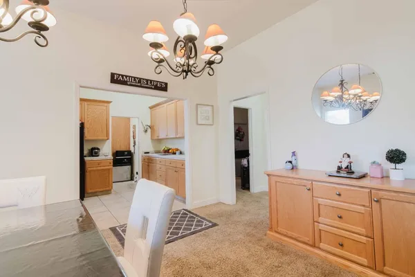 a bedroom with a chandelier and a dresser