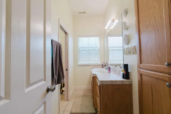 a bathroom with a tub sink and mirror