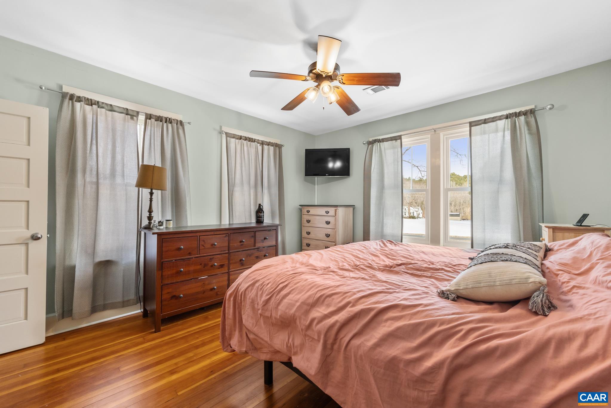 4615 Davis Highway Louisa, VA 23093 - Photo 17 of 29 a bedroom with a large bed a flat tv screen and dresser