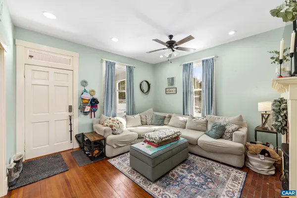 a living room with furniture a fireplace and a flat screen tv
