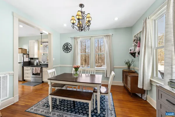 a view of a dining room with furniture and wooden floor