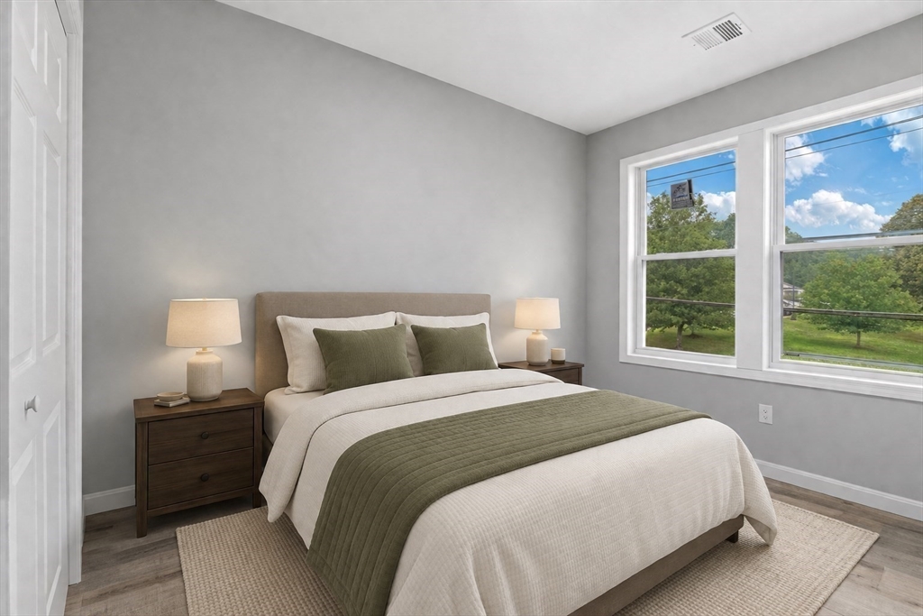 19 Brandon Road Dudley, MA 01571 - Photo 14 of 42 a bedroom with a bed and a large window
