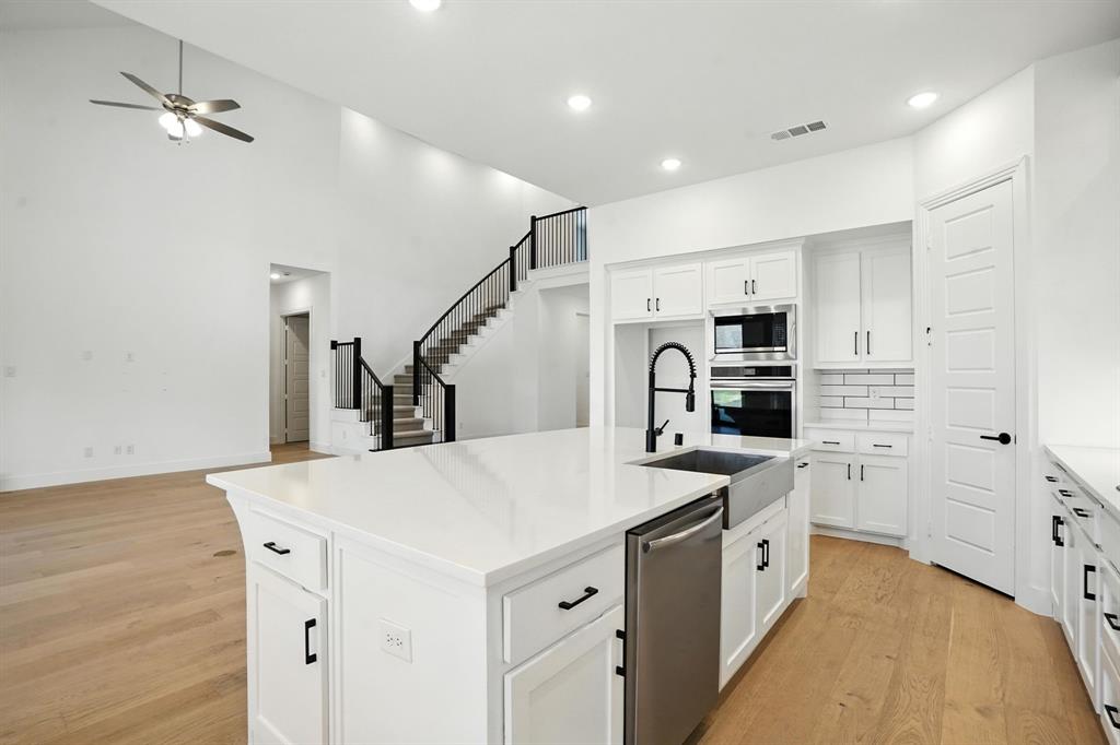 4621 Mount Vista Road Oak Point, TX 75068 - Photo 13 of 40 a kitchen with appliances a sink and cabinets