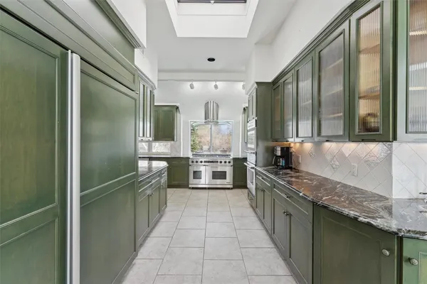 a kitchen with stainless steel appliances granite countertop a sink and stove