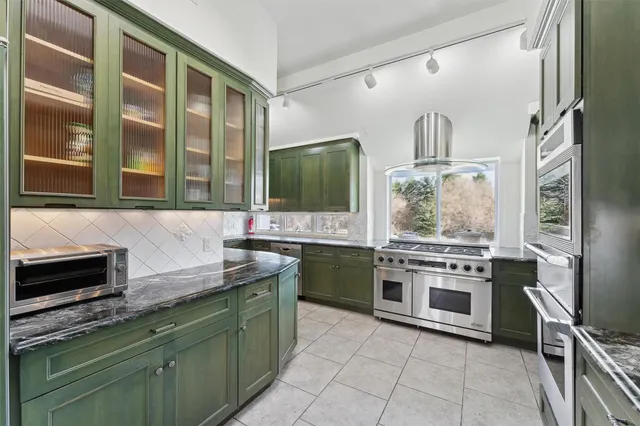 a kitchen with stainless steel appliances granite countertop a stove and a sink