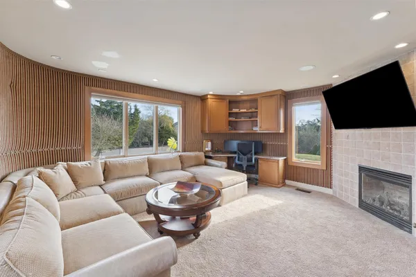 a living room with furniture a fireplace and a flat screen tv
