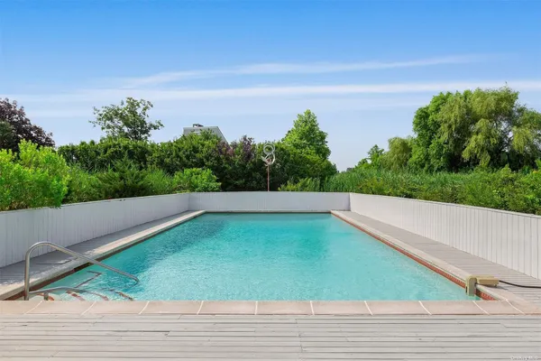 a view of a swimming pool with a yard