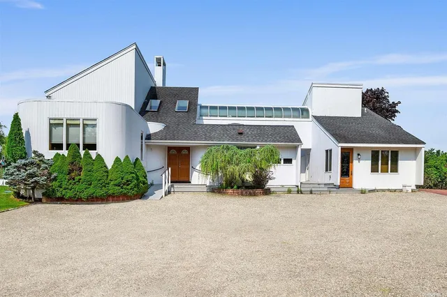 front view of a house with a bench