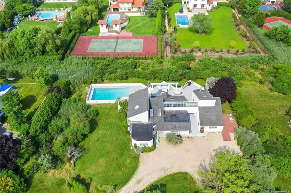 an aerial view of a house with yard swimming pool and outdoor seating