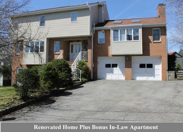 26 Rippowam Road Greenwich, CT 06807 - Photo 1 of 1 a front view of a house with a yard