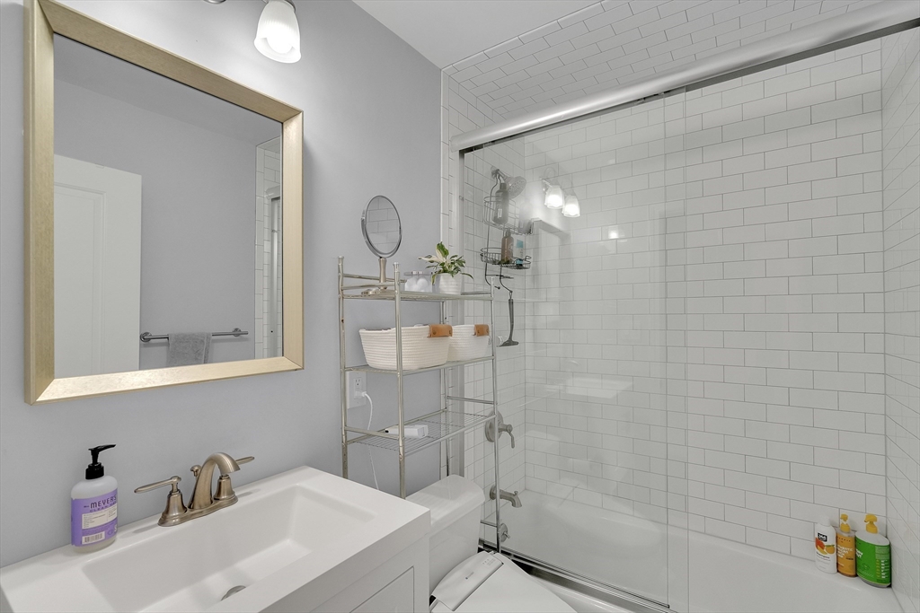 103 Stimson Street Boston, MA 02132 - Photo 7 of 10 a bathroom with a sink a toilet and shower