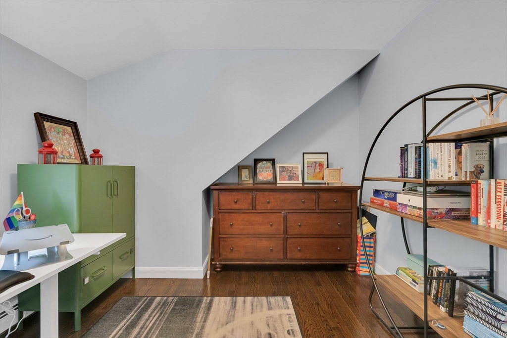 103 Stimson Street Boston, MA 02132 - Photo 9 of 10 a bedroom with a bed and wooden floor