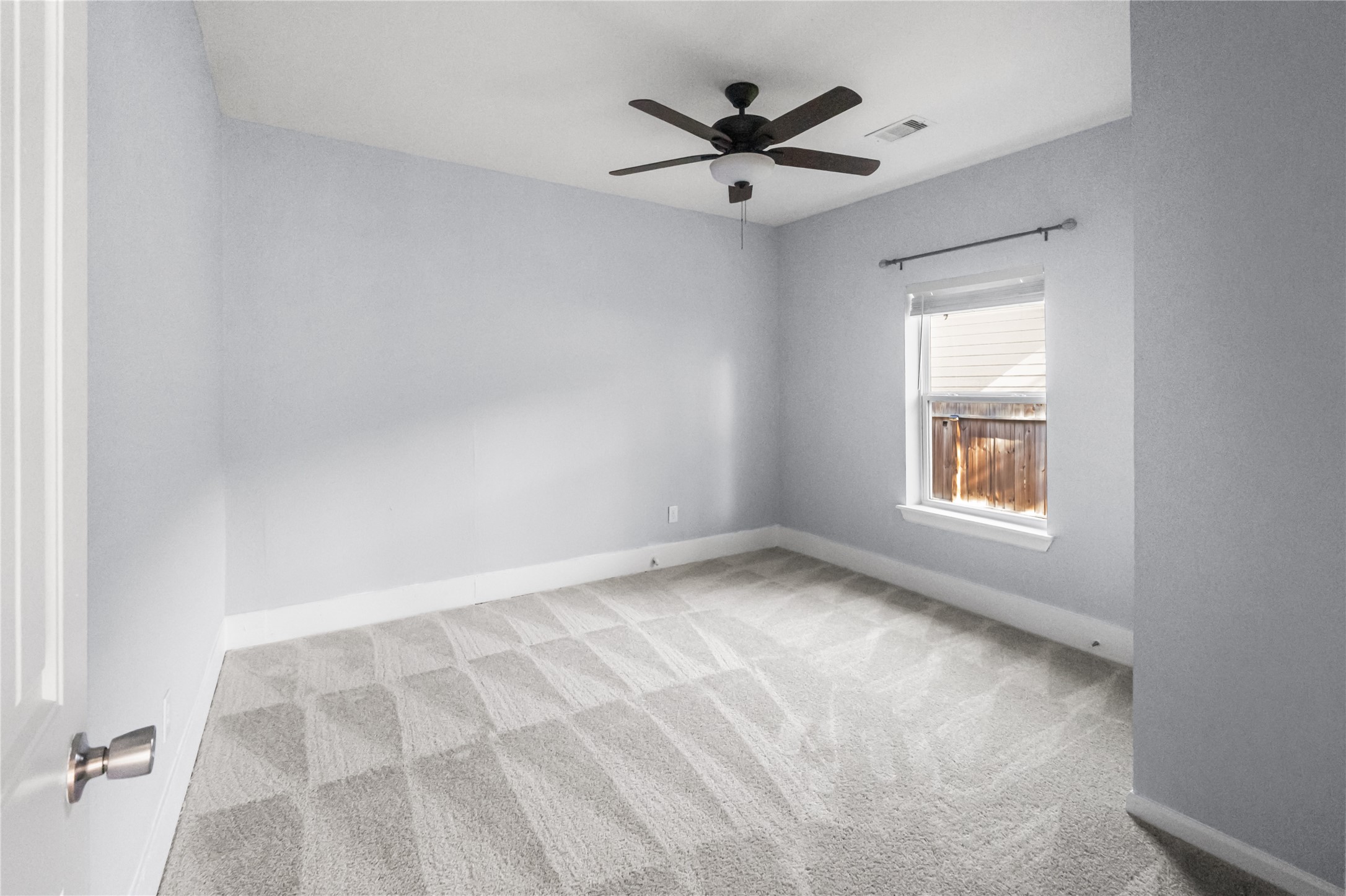 3108 Indiana Street Baytown, TX 77520 - Photo 12 of 20 an empty room with a window and a fan