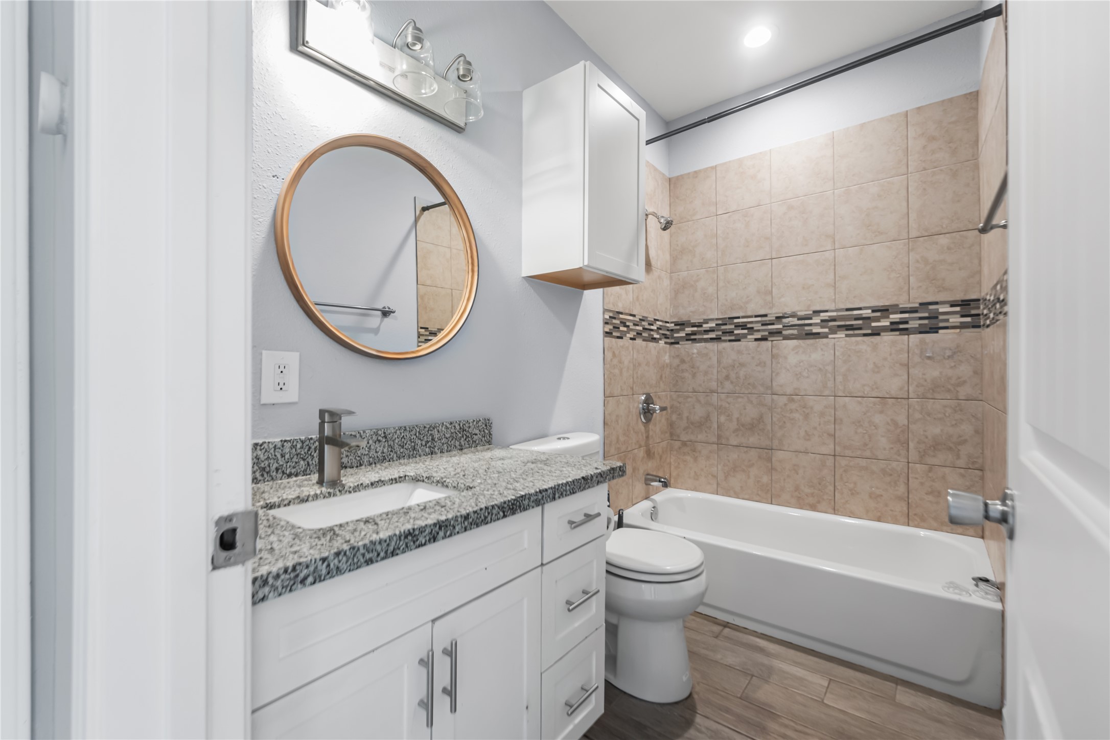 3108 Indiana Street Baytown, TX 77520 - Photo 15 of 20 a bathroom with a granite countertop toilet sink and mirror