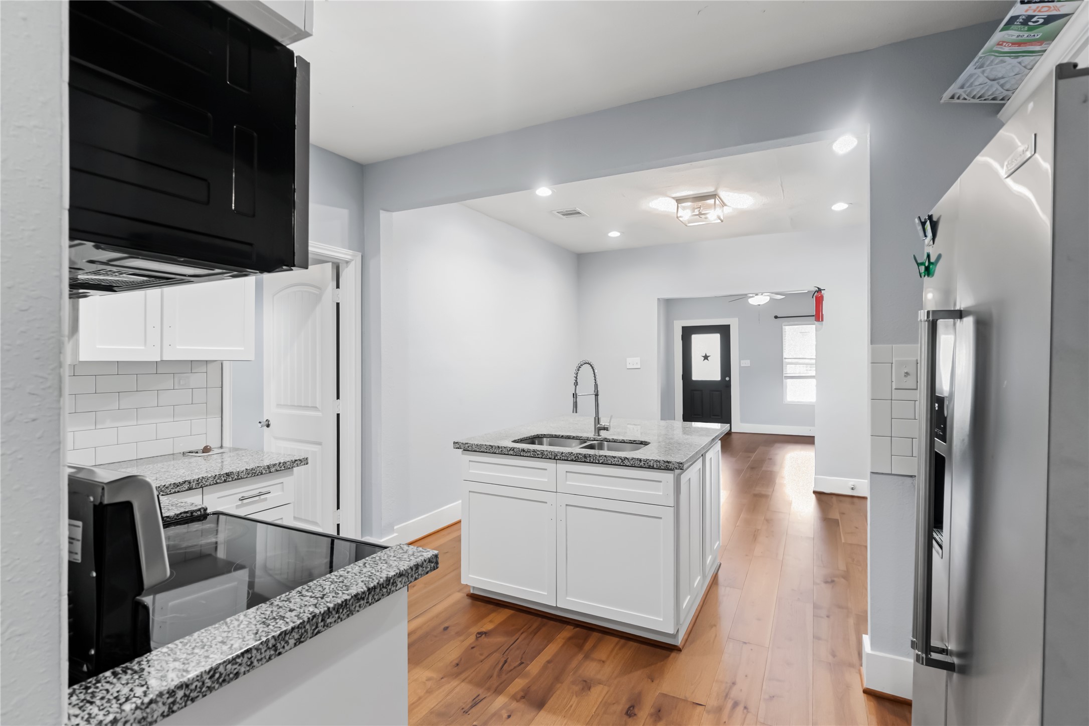 3108 Indiana Street Baytown, TX 77520 - Photo 6 of 20 a kitchen with stainless steel appliances granite countertop a refrigerator and a stove top oven